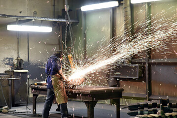 workers in an industrial plant - workplace foundry - production of steel castings - 785401272