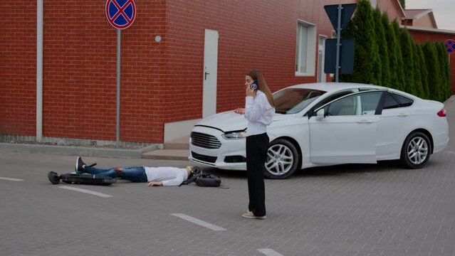 Road accident car struck scooter woman dials emergency services to assist injured person. Accident gravity of road accidents and imperative need for swift intervention to mitigate consequences.