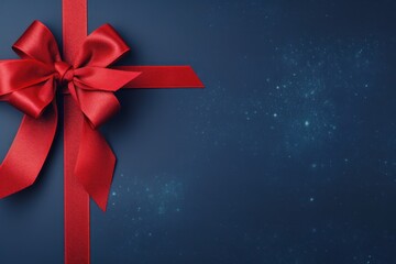 Red ribbon with bow on indigo background, Christmas card concept. Space for text. Red and Indigo Background