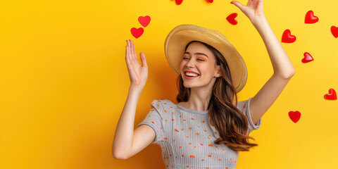 Happy young woman catching social likes hearts on yellow background with copy space. Creative concept of social networks, public approval.