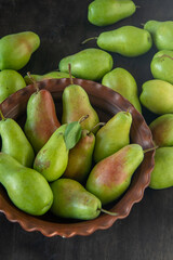Parisian pear variety. Fruits on the table. Autumn harvest. Pears top view background. Green yellow red color pear. Vitamin vegan food.