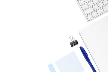 Stationery frame consisting of white notebook, white keyboard, light blue sticky notes, blue pen...