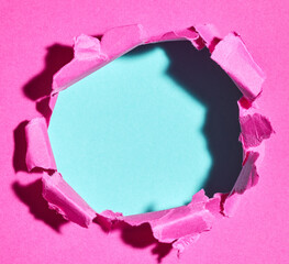 Ripped pink paper with hole in the center - 785410690