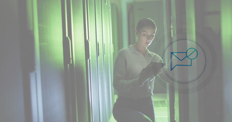 Image of message block icon over caucasian female engineer using digital tablet at server room