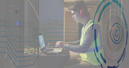 Image retina round scanner against asian male engineer using laptop at computer server room