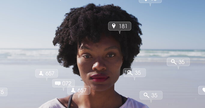 Image of social media data processing over african american woman on beach