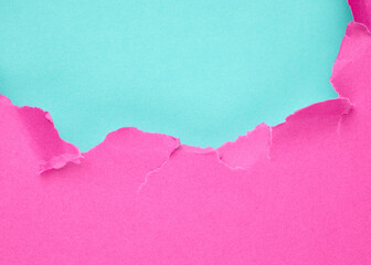 Ripped pink paper over turquoise blue