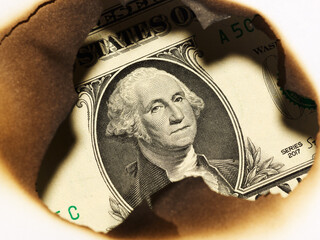 burnt savings concept background. one us dollar paper in hole - 785413264