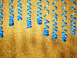Sparkling holiday golden background with blue ribbon - 785413811