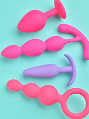 anal plugs and dildo sex toys over turquoise blue background - 785415426