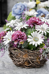 Detail of Easter decoration with mixed artificial and fresh flowers.