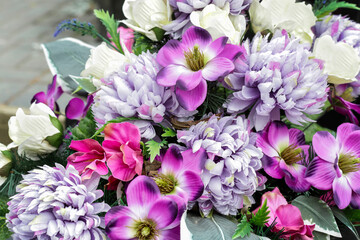 Beautiful decoration made of purple and pink artificial flowers.