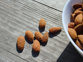Almonds nuts on old wood desk background. No cook energy bites on white wooden desk