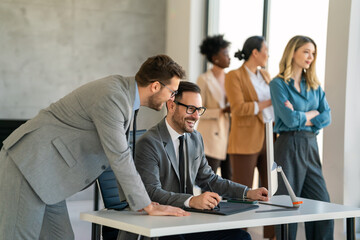 Group of young business people working as a team and communicating in corporate office