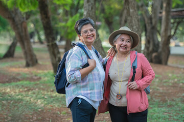 Asian tourists Take a backpack and walk through nature in one of Thailand's forest parks. The concept of going on vacation in retirement