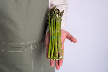 Green asparagus in the hands of a men. Bunch of ripe fresh asparagus. Healthy organic food. Cooking...