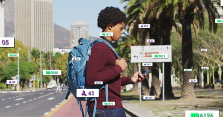Image of multiple notification bars over biracial man holding cellphone crossing street