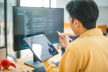 Young programmer working on coding, software development and web design in software company...