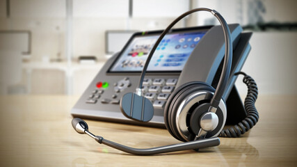 Modern VoIP phone and headset standing on wooden office table. Call center, marketing and technical support concept. 3D illustration