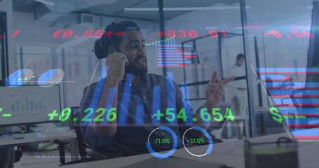 Image of financial data processing over smiling man in office using smartphone and computer - Powered by Adobe