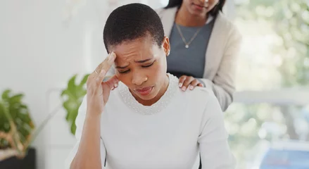 Fotobehang Empathy, anxiety and friends with black woman in office for stress, pain and support. Burnout, mental health and tired with female employee and migraine in agency for frustrated, sad and fatigue © peopleimages.com