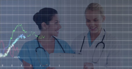 Image of financial data processing over two caucasian female doctors