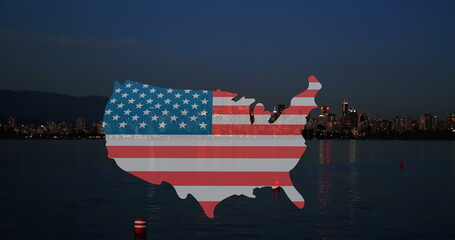 Image of map of usa with usa flag appearing over night cityscape