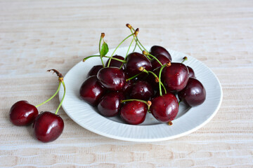 a plate of cherries on it isolated close up 