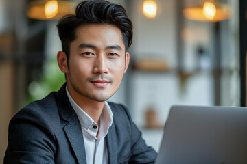 Portrait of young confident Asian sales executive