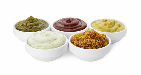 Many different sauces in bowls on white background
