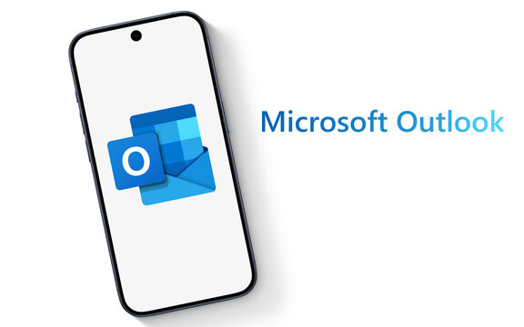 Outlook Logo is displayed on a modern smartphone, laying on a white underground with Microsoft Outlook lettering, email client, with functions as calendaring, task managing, contact managing, notes