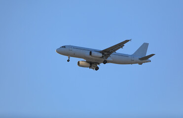 passenger plane in the blue sky - 785447610