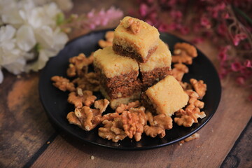 Famous Indian sweet Kalakand Made Of Khoya Doodh Malai Decorated With Badam Or Badaam garnished with Nuts Kaju And Pista closeup with selective focus and blur
