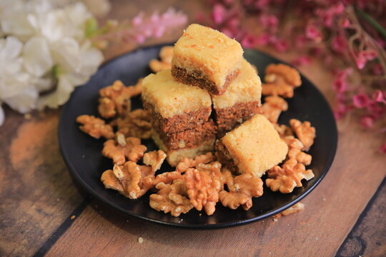 Famous Indian sweet Kalakand Made Of Khoya Doodh Malai Decorated With Badam Or Badaam garnished with Nuts Kaju And Pista closeup with selective focus and blur
