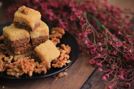 Famous Indian sweet Kalakand Made Of Khoya Doodh Malai Decorated With Badam Or Badaam garnished with Nuts Kaju And Pista closeup with selective focus and blur