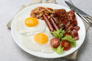 Delicious breakfast with sunny side up eggs on light table, closeup