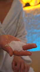 woman with salt in her hand in the salt room