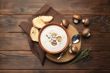 Obraz na płótnie Canvas Fresh homemade mushroom soup served on wooden table, flat lay