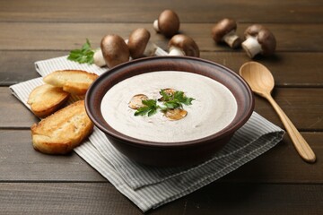 Fresh homemade mushroom soup served on wooden table