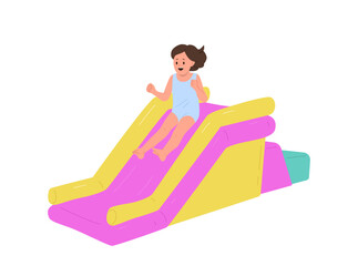 Overjoyed little girl child cartoon character having fun sliding in mini inflatable attraction