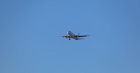 passenger plane in the blue sky - 785455674