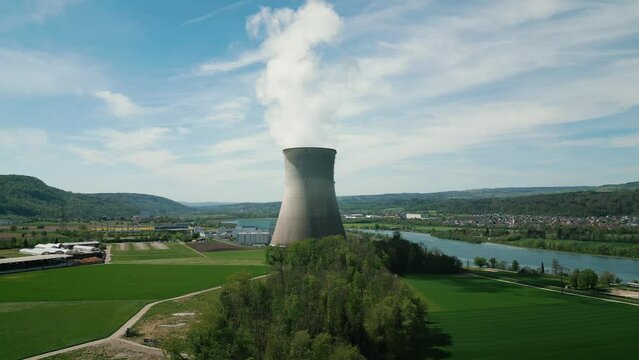 Nuclear power plant in Switzerland. Atomic power station with cooling tower
