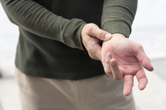 middle aged old asian man suffering from trigger finger, cps or carpal tunnel syndrome, gout disease, arthritis inflammation, hand pain, health care or body care concept image