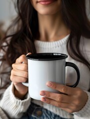 A female model with long dark hair, holding a white ceramic coffee mug with a black handle