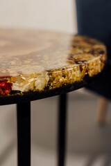 Table made of epoxy resin. Sea table. There is furniture in the room.	