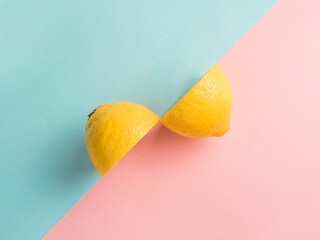Two lemon halves on two-color background. Creative
