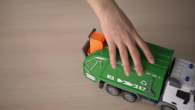 toy truck. recyclable materials. garbage disposal machine. slow motion video. High-quality shooting in 4K