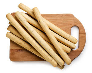 Grissini bread sticks on a wooden board closeup on a white. Top view