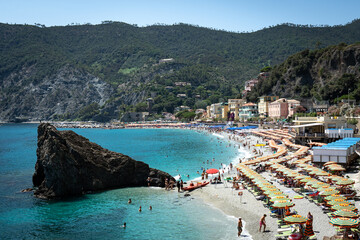 Cinque Terre, Italy - August 17 2023: Cinque Terre Monterosso seashore with trees, sea and...