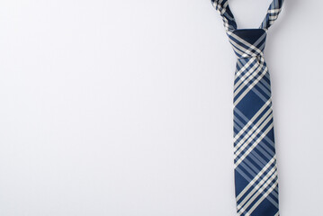 Ready for a Father's Day festivity? Top-down view of an elegant tie on white, ideal for your personalized greeting or promotion